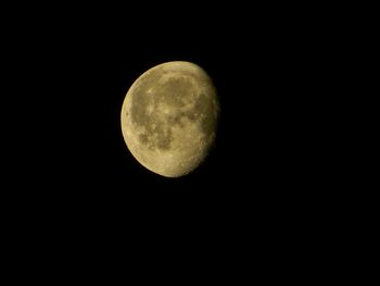 Low angle view of moon against dark sky