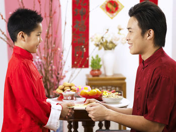 Father greeting son during festival