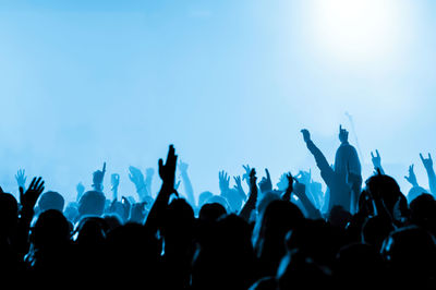 Rear view of silhouette crowd enjoying during music concert