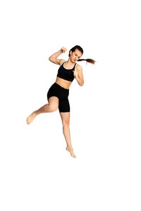 Full length of woman jumping against white background