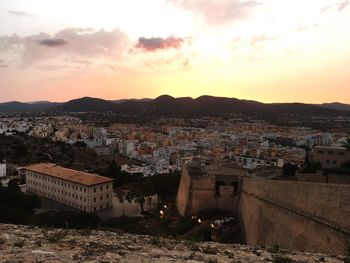 High angle shot of townscape against sky at sunset