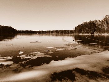 Scenic view of calm lake against clear sky