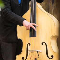 Midsection of man playing violin