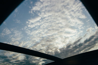 Low angle view of sky seen through glass window