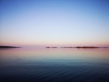 Scenic view of sea against clear sky during sunset