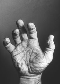 Close-up of human hand against black background
