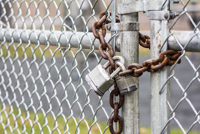 Close-up of padlock on chainlink fence