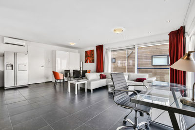 Empty chairs and tables on tiled floor at home