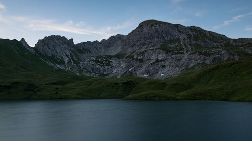 Scenic view of lake and mountains against sky