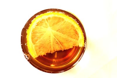 Directly above shot of orange slice against white background