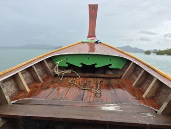 Close-up of boat moored on sea against sky