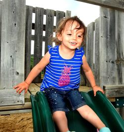 Portrait of a smiling girl sitting outdoors