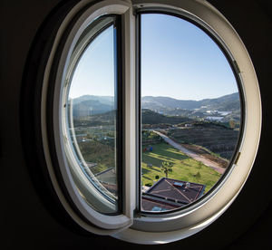 Scenic view of mountains seen through vehicle window