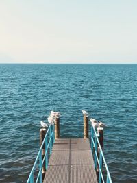 Boat sailing on sea against clear sky