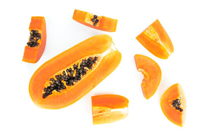 Close-up of orange slice over white background