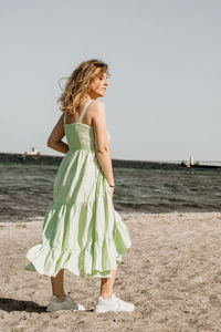 Young woman standing at beach