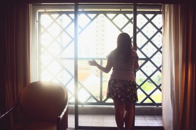 Woman looking through window