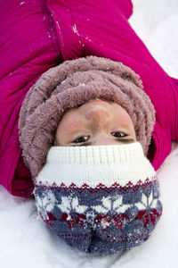 Close-up portrait of teenage girl on snow field