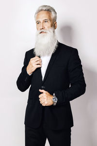 Portrait of businessman standing against white background