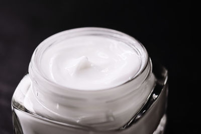 Close-up of moisturizer against black background