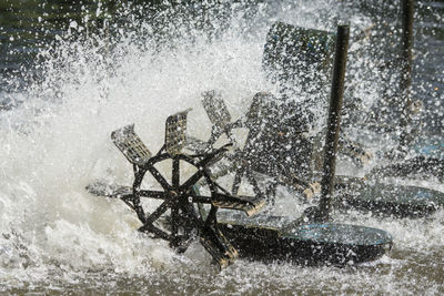 Water wheel splashing in river