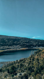 Scenic view of river against clear blue sky