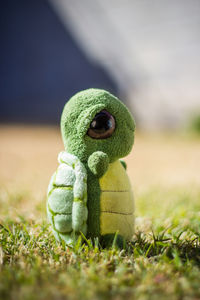 Close-up of stuffed toy on field