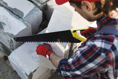 Side view of man working at construction site