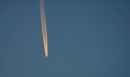 Low angle view of vapor trail against clear blue sky