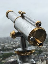 Close-up of coin-operated binoculars against sky