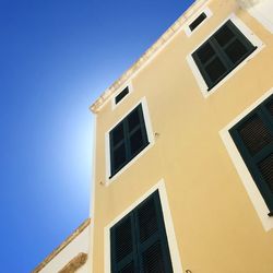 Low angle view of building against clear blue sky