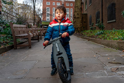 Full length portrait of boy on bicycle