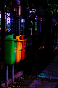 Illuminated lamp on footpath in city at night