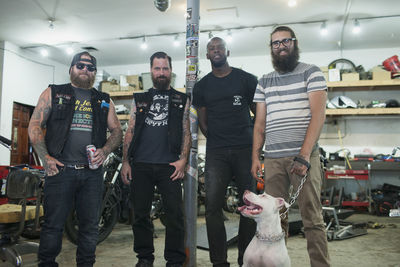 A group of young men with a dog.