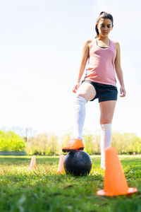 Full length of young woman standing on field