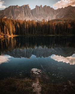 Scenic view of lake by trees against sky