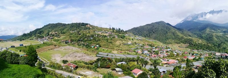 Panoramic view of trees and mountains against sky