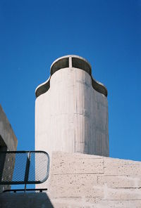 Low angle view of water tower against clear blue sky