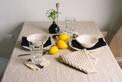 Vintage table setting with linen napkins and yellow lemons.