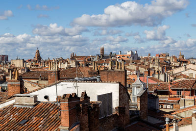 High angle view of buildings in city against sky