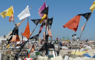 Multi colored umbrellas flags against clear sky