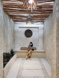 Low angle view of woman sitting on staircase