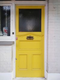 Yellow front door on british house 