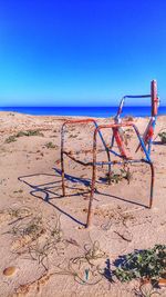 Scenic view of beach against clear blue sky