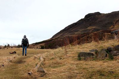 Rear view of woman standing on landscape