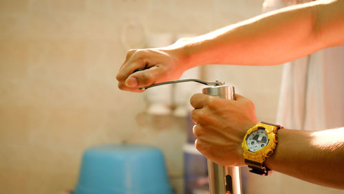 Close-up of hands holding peppermill