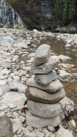 Close-up of stone stack on shore