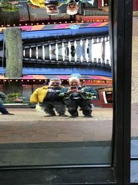 Reflection of people on glass window
