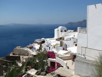 High angle view of buildings by sea against sky