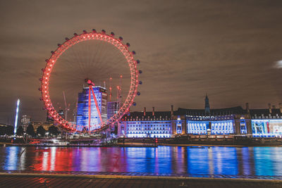 Illuminated ferris wheel at night